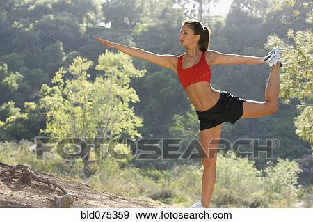 Stock Photo - Hispanic woman stretching. Fotosearch