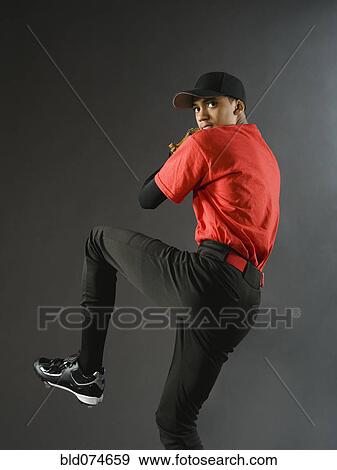 Mixed race baseball pitcher ready to pitch ball View Large Photo Image Stock Photo - Mixed race baseball pitcher ready to pitch ball. Fotosearch