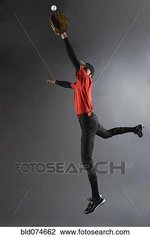 Mixed race baseball player catching ball View Large Photo Image Stock Image - Mixed race baseball player catching ball. Fotosearch