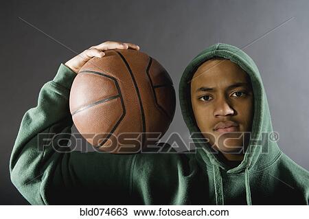 Mixed race boy holding basketball View Large Photo Image Stock Image - Mixed race boy holding basketball. Fotosearch