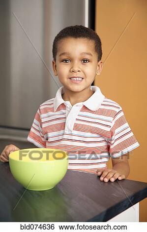 Mixed race boy with bowl in kitchen View Large Photo Image Stock Photograph - Mixed race boy with bowl in kitchen. Fotosearch