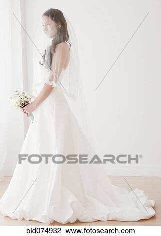 Stock Image - Mixed race bride in wedding dress. Fotosearch