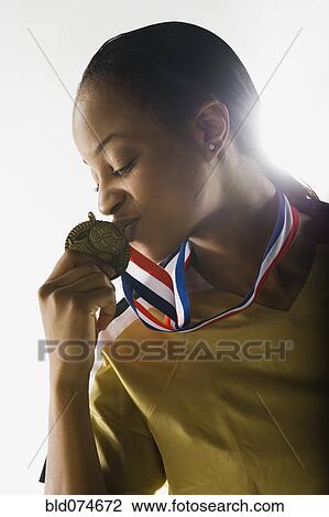 Mixed race soccer player kissing award medal View Large Photo Image Stock Image - Mixed race soccer player kissing award medal. Fotosearch