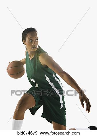 Stock Photo - Mixed race woman playing basketball. Fotosearch