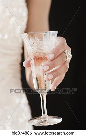 Woman holding champagne flute View Large Photo Image Stock Photography - Woman holding champagne flute. Fotosearch