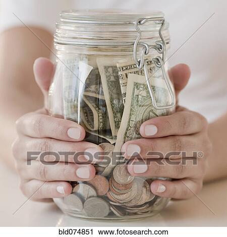 Woman holding jar with money View Large Photo Image Stock Image - Woman holding jar with money. Fotosearch