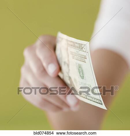 Woman holding twenty dollar bill View Large Photo Image Picture - Woman holding twenty dollar bill. Fotosearch