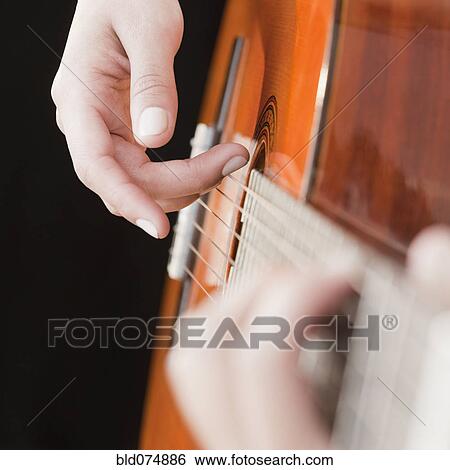 Woman playing guitar View Large Photo Image Stock Photograph - Woman playing guitar. Fotosearch