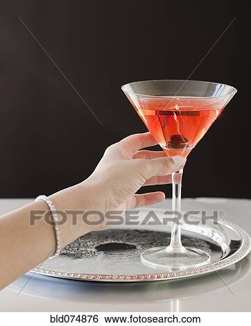 Woman reaching for martini on tray View Large Photo Image Stock Photograph - Woman reaching for martini on tray. Fotosearch