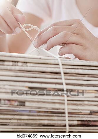 Stock Photo - Woman recycling newspapers. Fotosearch