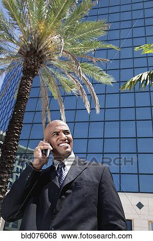 Stock Photo - African businessman talking on cell phone. Fotosearch
