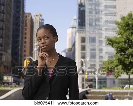 African businesswoman on street looking pensive View Large Photo Image Stock Image - African businesswoman on street looking pensive. Fotosearch