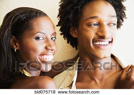 African couple hugging and smiling View Large Photo Image Stock Photo - African couple hugging and smiling. Fotosearch