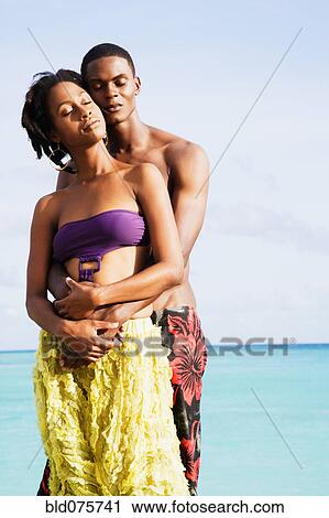 African couple hugging with eyes closed on beach View Large Photo Image Stock Image - African couple hugging with eyes closed on beach. Fotosearch