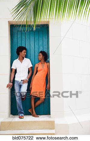 Stock Image - African couple standing in doorway. Fotosearch
