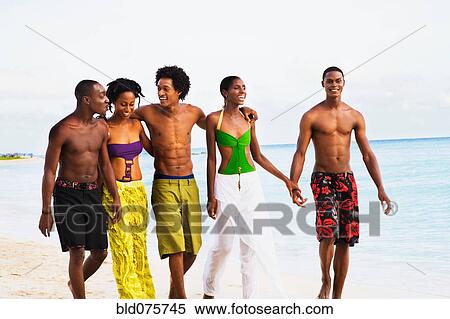 African friends walking on beach View Large Photo Image Stock Photography - African friends walking on beach. Fotosearch