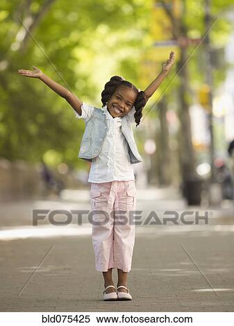 African girl smiling with arms raised View Large Photo Image Stock Photography - African girl smiling with arms raised. Fotosearch