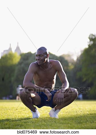 African man crouching in park View Large Photo Image Stock Photo - African man crouching in park. Fotosearch