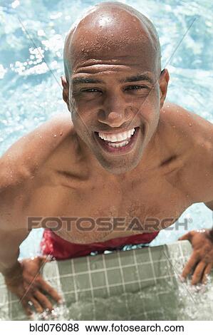 African man jumping out of swimming pool View Large Photo Image Stock Photo - African man jumping out of swimming pool. Fotosearch
