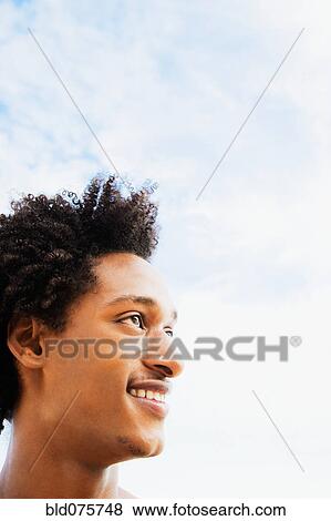 Stock Photo - African man looking up and smiling. Fotosearch