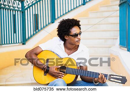 Stock Photography - African man playing guitar. Fotosearch