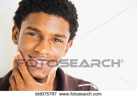 African man rubbing chin and smiling View Large Photo Image Stock Photo - African man rubbing chin and smiling. Fotosearch