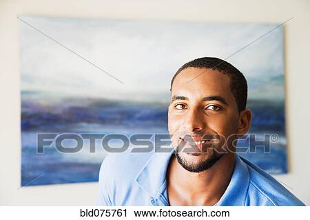 African man standing in front of painting View Large Photo Image Stock Image - African man standing in front of painting. Fotosearch