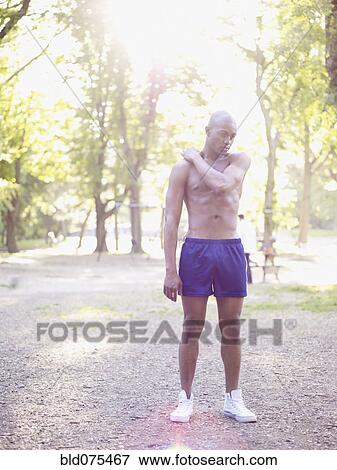 African man standing in park with bare chest View Large Photo Image Stock Photo - African man standing in park with bare chest. Fotosearch