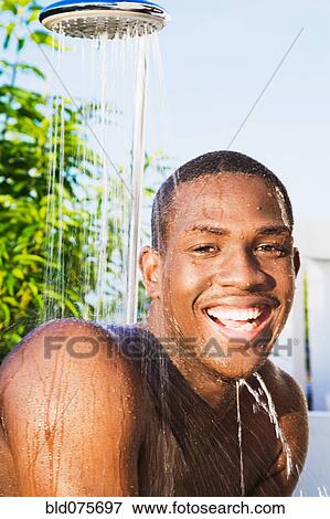 African man using outdoor shower View Large Photo Image Stock Photo - African man using outdoor shower. Fotosearch