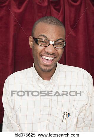 African man wearing taped eyeglasses and making a face View Large Photo Image Stock Photography - African man wearing taped eyeglasses and making a face. Fotosearch