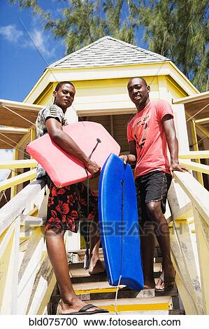 African men holding body boards View Large Photo Image Stock Image - African men holding body boards. Fotosearch