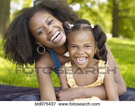 African mother and daughter laughing View Large Photo Image Stock Photo - African mother and daughter laughing. Fotosearch