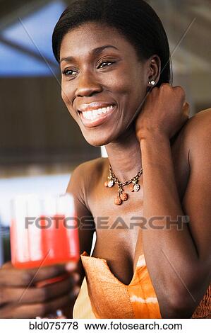 Stock Photo - African woman drinking cocktail. Fotosearch