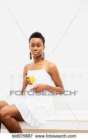African woman holding orange juice View Large Photo Image Stock Photo - African woman holding orange juice. Fotosearch