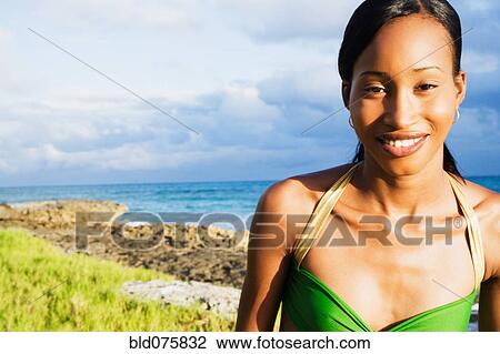 African woman smiling with ocean in background View Large Photo Image Stock Image - African woman smiling with ocean in background. Fotosearch