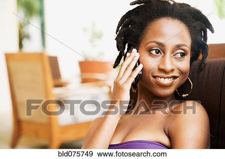 African woman talking on cell phone View Large Photo Image Stock Photo - African woman talking on cell phone. Fotosearch