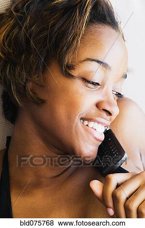 African woman talking on cell phone View Large Photo Image Stock Photo - African woman talking on cell phone. Fotosearch