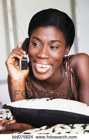 Picture - African woman talking on telephone. Fotosearch