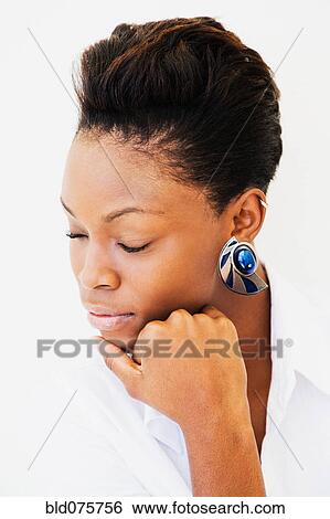 Stock Photograph - African woman with eyes closed. Fotosearch