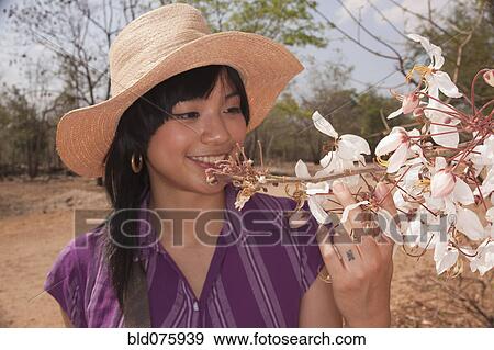 Chinese woman looking at flowering tree View Large Photo Image Stock Photo - Chinese woman looking at flowering tree. Fotosearch