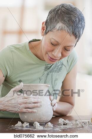 Chinese woman shaping clay pot View Large Photo Image Stock Image - Chinese woman shaping clay pot. Fotosearch