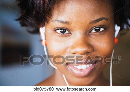 Close up of African woman wearing headphones View Large Photo Image Stock Image - Close up of African woman wearing headphones. Fotosearch