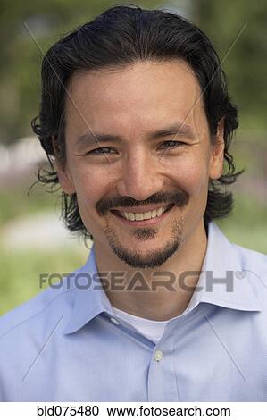 Stock Image - Close up of smiling mixed race man. Fotosearch