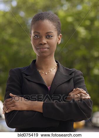 Confident African businesswoman with arms crossed View Large Photo Image Stock Photo - Confident African businesswoman with arms crossed. Fotosearch
