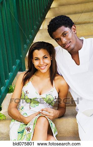 Stock Image - Couple sitting on steps. Fotosearch