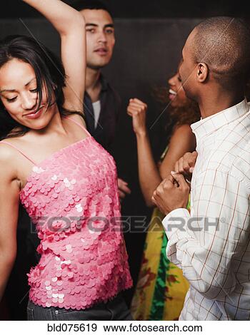 Stock Photo - Couples dancing at nightclub. Fotosearch