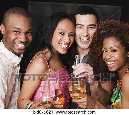 Stock Image - Couples drinking at bar. Fotosearch