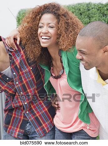 Friends hugging and laughing View Large Photo Image Stock Image - Friends hugging and laughing. Fotosearch
