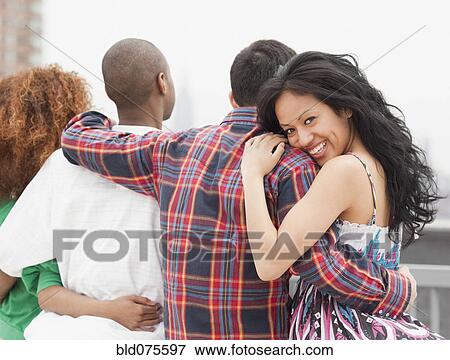 Stock Photo - Friends hugging. Fotosearch