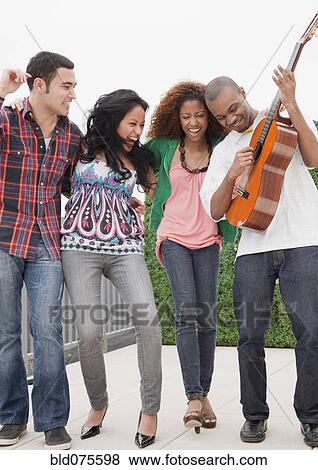 Stock Photo - Friends playing guitar. Fotosearch